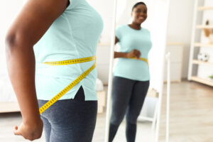 Woman measuring her waist