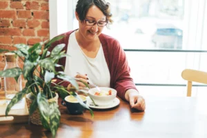 Adult brunette woman having a positive meal experience